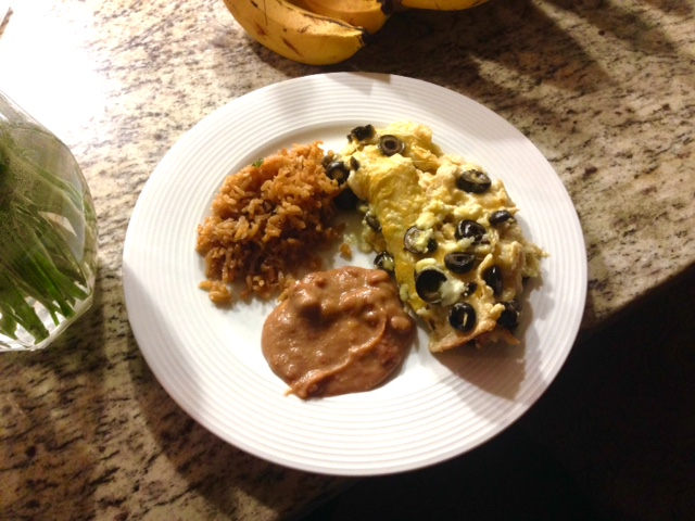 homemade dinner at a friends house enchiladas, rice, and beans
